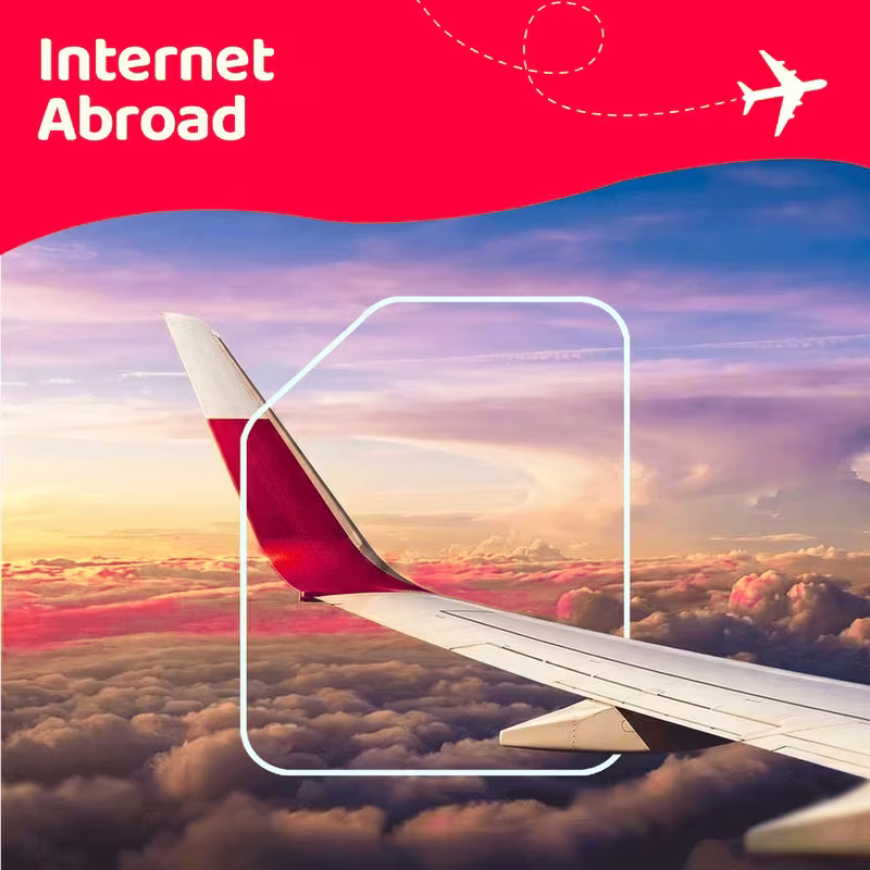 Internet abroad — airplane wing above the clouds